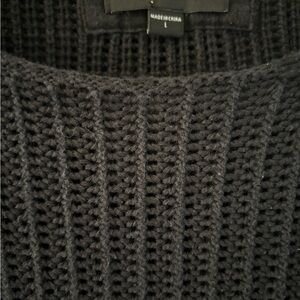 Men’s black sweater with frayed collar.